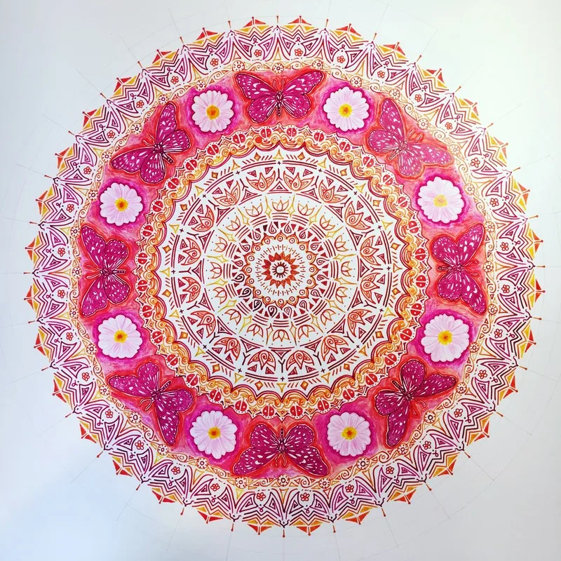 hand drawn pen and ink mandala with flowers, butterflies